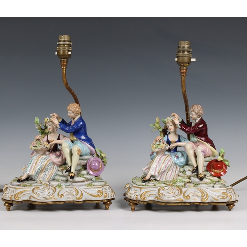 66 - A pair of Capodimonte porcelain table lamps modelled as a courting couple on scrolling bases support... 