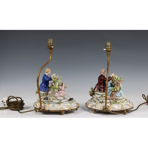 66 - A pair of Capodimonte porcelain table lamps modelled as a courting couple on scrolling bases support... 