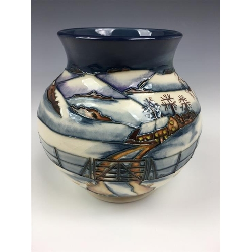 79 - A Moorcroft Woodside Farm pattern baluster vase dated 1999, decorated with foxes in a snowy landscap... 