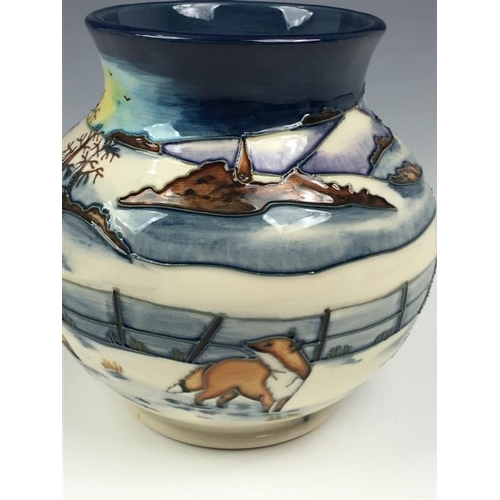 79 - A Moorcroft Woodside Farm pattern baluster vase dated 1999, decorated with foxes in a snowy landscap... 