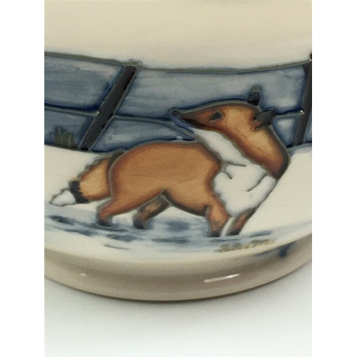 79 - A Moorcroft Woodside Farm pattern baluster vase dated 1999, decorated with foxes in a snowy landscap... 