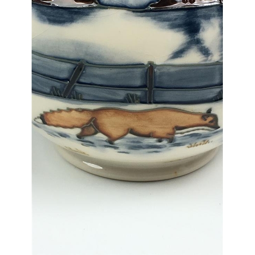 79 - A Moorcroft Woodside Farm pattern baluster vase dated 1999, decorated with foxes in a snowy landscap... 