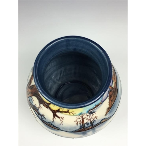 79 - A Moorcroft Woodside Farm pattern baluster vase dated 1999, decorated with foxes in a snowy landscap... 