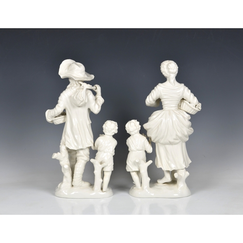 87 - A pair of modern Italian white glazed figures of a farmer and flower maiden with children from the f... 