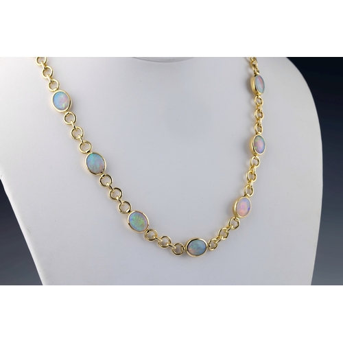 637 - An 18ct yellow gold and opal necklace the cable chain set with thirteen oval cabochon opals in close... 