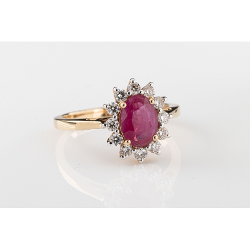 648 - A ruby and diamond cluster ring The central oval-cut ruby in a surround of twelve brilliant-cut diam... 