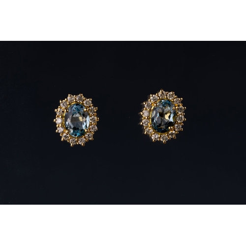 674 - A pair of aquamarine and diamond cluster ear studs The central oval-shaped aquamarines in a surround... 