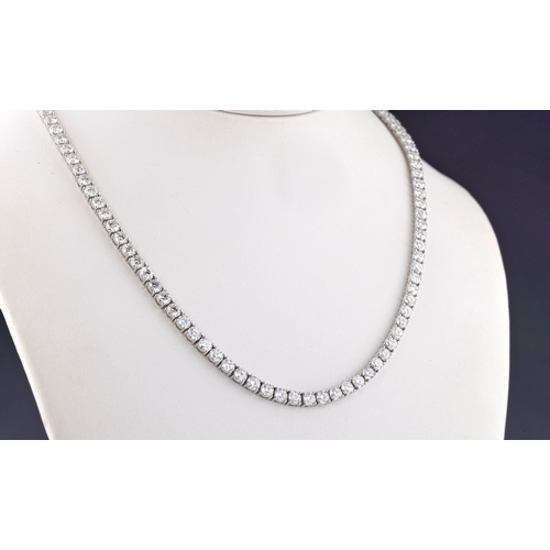 676 - An 18ct white gold and diamond line necklace with one hundred and two claw set, brilliant cut diamon... 