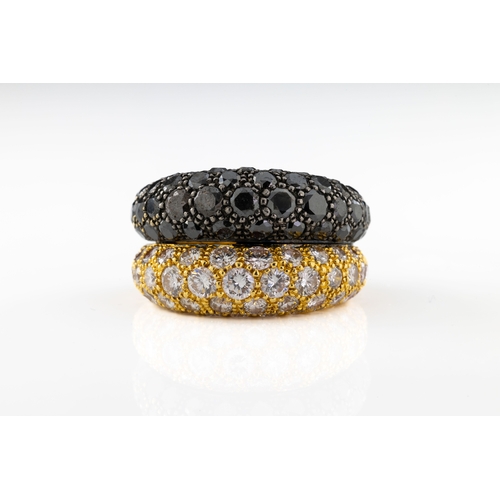 678 - A black and white diamond double bombe ring Of symmetric double bombe form, in 18ct yellow gold, eac... 