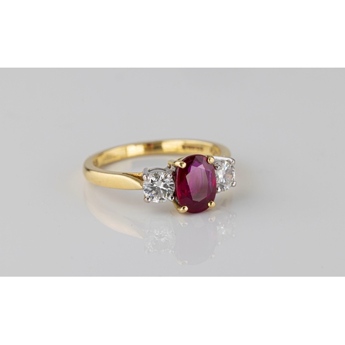 690 - An 18ct yellow gold, ruby and diamond three stone ring the central, 8 x 6mm. oval cut, vivid purplis... 