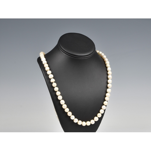 694 - A single strand cultured pearl necklace the evenly sized 7.5mm. pearls with a diamond set 14ct gold ... 