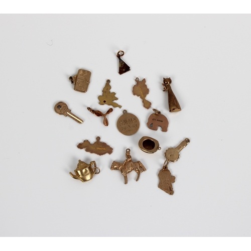 740 - A collection of 9ct gold charms to include outline maps of England, Ireland, Sark, Alderney, key, ba... 