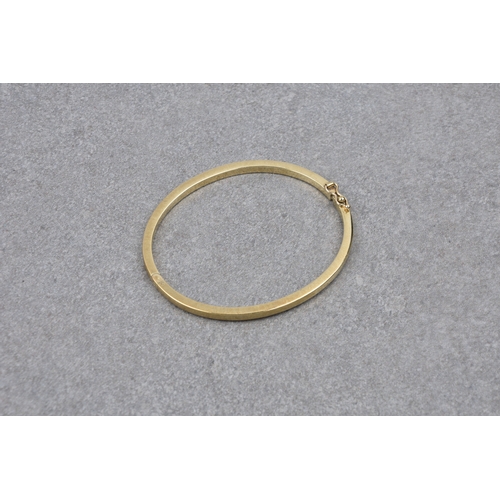 780 - A 9ct yellow gold hinged plain bangle hallmarked '375', 6 x 5.1cm. internal diameter.