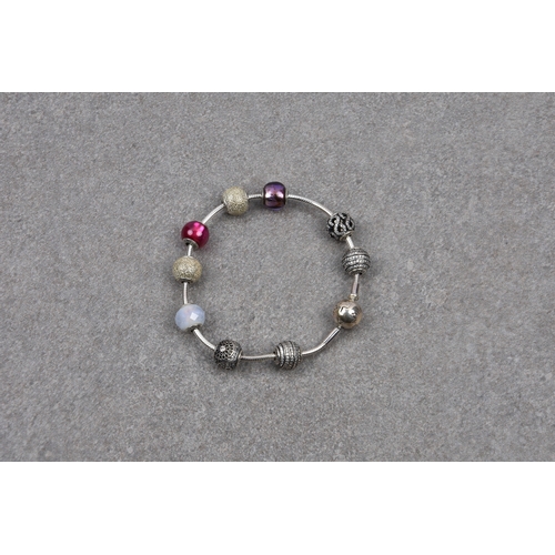 782 - A Pandora bracelet with nine silver ball charms in a Pandora box.