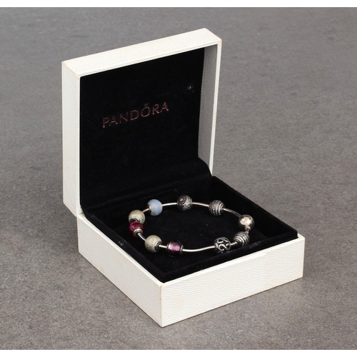 782 - A Pandora bracelet with nine silver ball charms in a Pandora box.