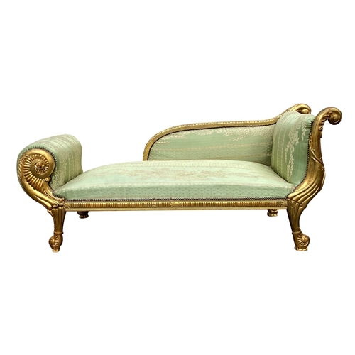 530A - An Empire style chaise longue, first half 20th century, with serpentine reel moulded back and serpen... 