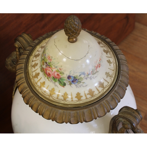 70A - A pair of Sevres style porcelain urn shaped lidded vases ormolu mounted, hand painted with elegant f... 