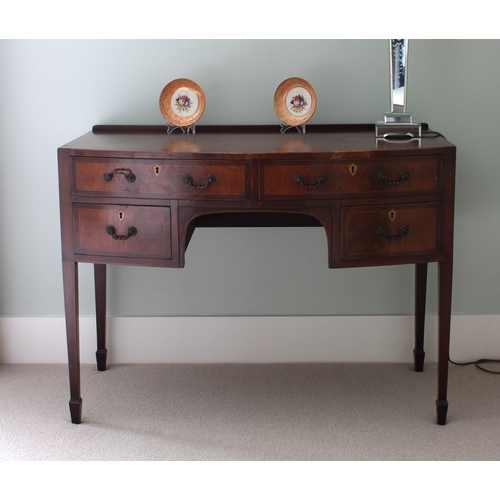 192 - A late George III mahogany bowfront dressing table the inlaid crossbanded top with rear gallery over... 