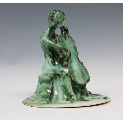 20 - Guernsey Studio pottery - Elizabeth Ann Macphail (1939-89) A green glazed stylised cellist or double... 