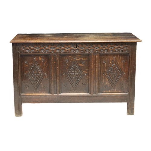 201 - An English 18th century coffer with a three plank top over three diamond carved panels and a blind f... 