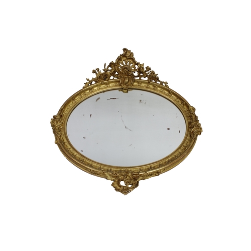 211 - A French, late 19th century, oval gilded Rococo style mirror with original gilding, 38½ x 42in. (97.... 