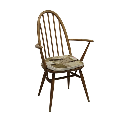 215 - A mid 20th century Ercol blonde elm stick back dining chair with padded seat.