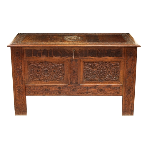 216 - An early 20th century carved oak coffer the panelled top with C.E.L. to central cartouche and foliat... 