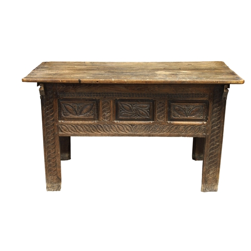 226 - A Breton/Norman 18th century oak dough bin the slide on four plank top over three fielded panels to ... 