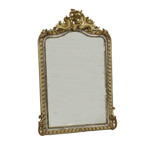 228 - A modern gilt wood and gesso mirror variously painted in silver and cream, with scrolling rococo sty... 