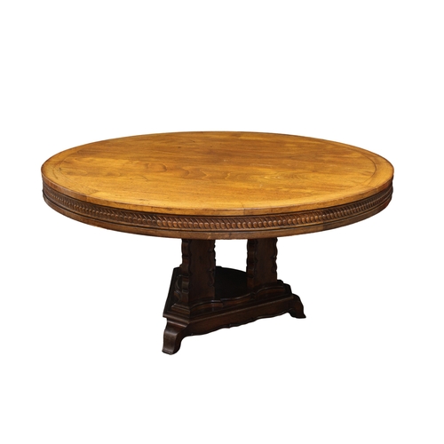 230 - A continental crossbanded mahogany breakfast table the circular top over a frieze carved with abstra... 