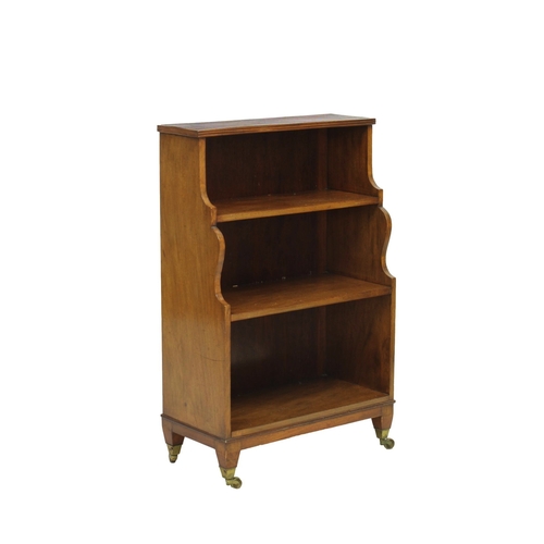 241 - Small three tier mahogany waterfall bookcase the reeded top over shaped sides and three shelves, rai... 