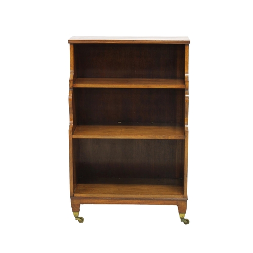 241 - Small three tier mahogany waterfall bookcase the reeded top over shaped sides and three shelves, rai... 