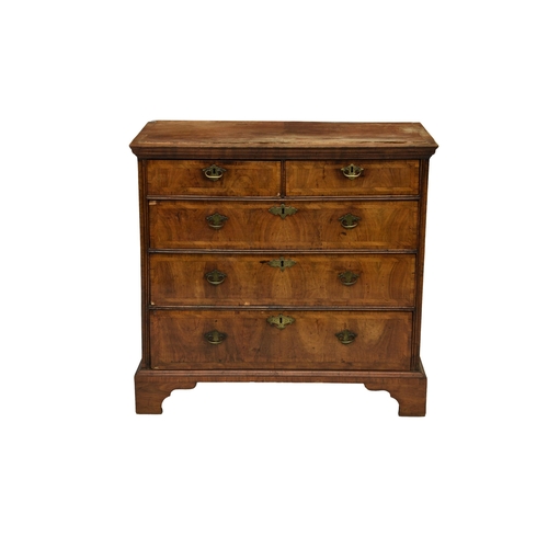 244 - A George I walnut chest of drawers alterations, the flared, ogee moulded cross banded top over two s... 