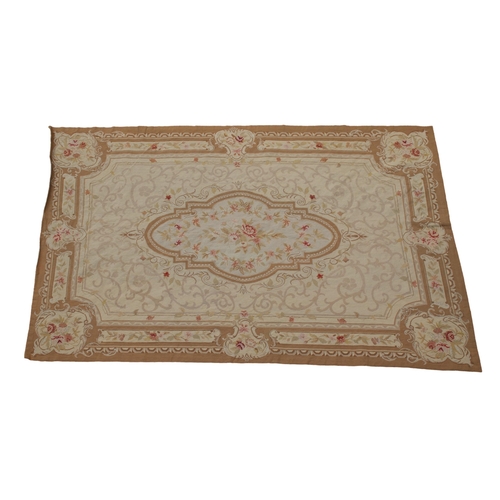 246 - A large flatweave rug with Aubusson design in light browns, pale pink and red, with a floral medalli... 