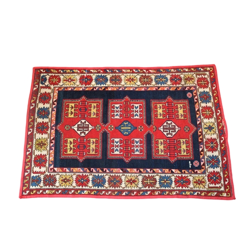 248 - A Kazak triple medallion flat weave rug the medallions on a blue ground between reciprocating and cr... 