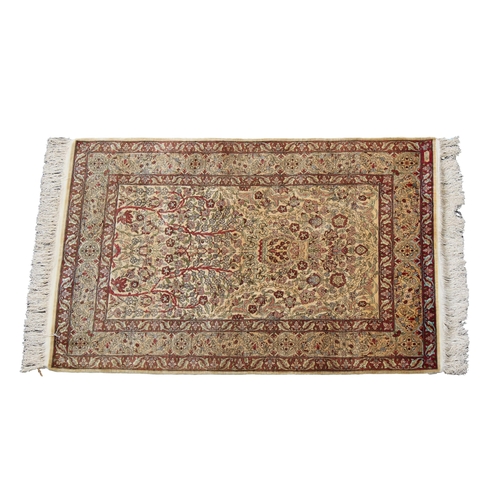 254 - A signed Turkish silk Hereke rug with a Tree of Life design on an ivory field, flanked by floral and... 