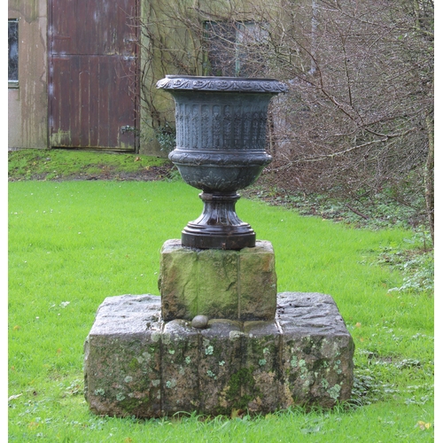 267 - A pair of cast iron Campana form garden urns decorated with a swagged and festooned shoulder, foliat... 