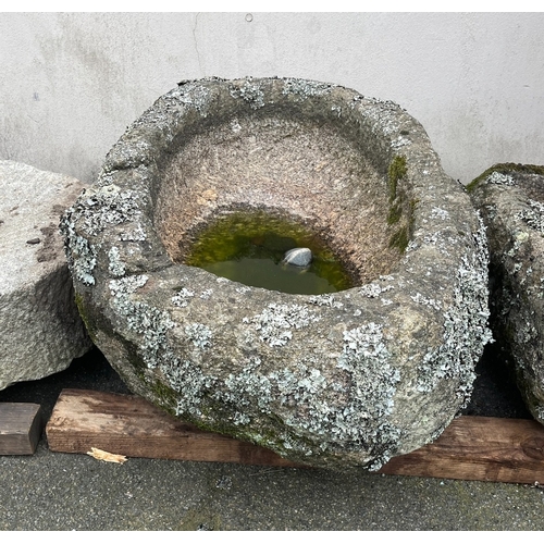 283 - A weathered oval granite trough covered in lichen, having deep chiselled bowl, 35 x 23in. (88.8 x 58... 