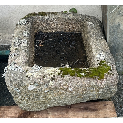 284 - A weathered rounded rectangular granite trough 25½ x 19in. (64.7 x 48.2cm.), 11in. (28cm.) deep.