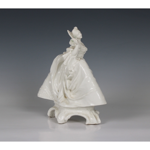 77 - A Nymphenburg white porcelain figure of a lady with a fan circa 1920, perhaps from a model by J.P.R.... 