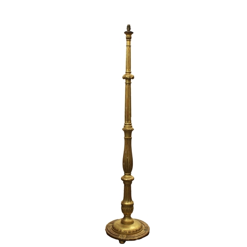 236 - A carved gilt wood standard lamp the reeded and carved central column with a gadrooned and stepped b... 