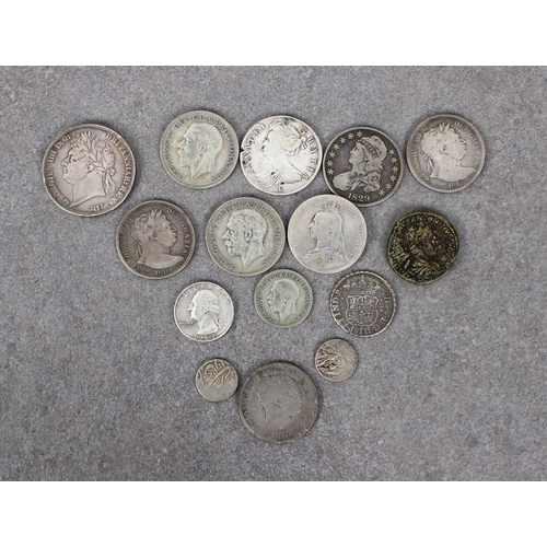 32 - A collection of antique Worldwide silver coinage To include a 1821 Great Britain George III Crown; t... 