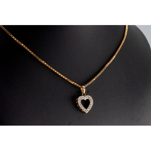 1051 - A diamond heart shaped pendant in 9ct yellow gold, illusion set with four diamonds, suspended from a... 