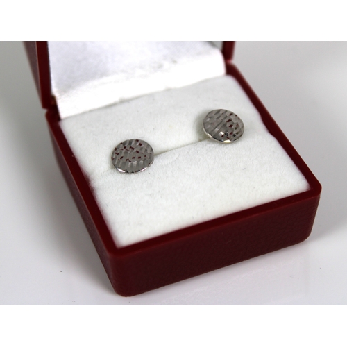 1059 - A pair of 18ct white gold disc stud earrings.