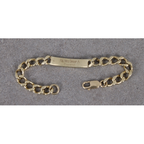 1061 - A 9ct yellow gold curb link identity bracelet 18.8cm. long.