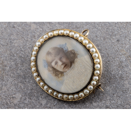 1063 - Gold and pearl portrait miniature brooch of a girl wearing blue bows, wishing a seed pearl surround,... 