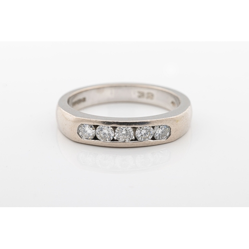 1068 - A diamond five stone ring in 18ct white gold with five channel-set brilliant-cut diamonds, ring size... 