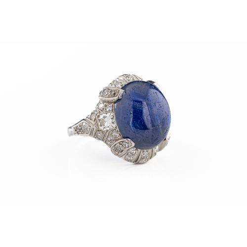 1084 - An Art Deco platinum star sapphire and diamond cocktail ring, the oval cabochon six-ray star sapphir... 