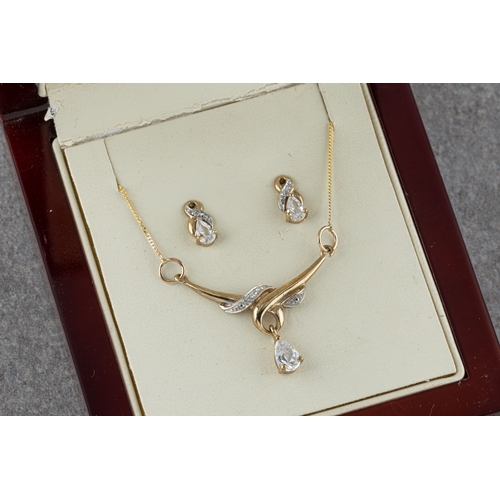 1144 - A 9ct yellow gold and cubic zirconia pendant the stylised yellow and white gold pendant suspending a... 