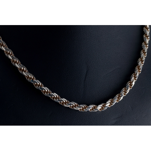 1145 - A silver rope twist chain length 18in. (46cm.).